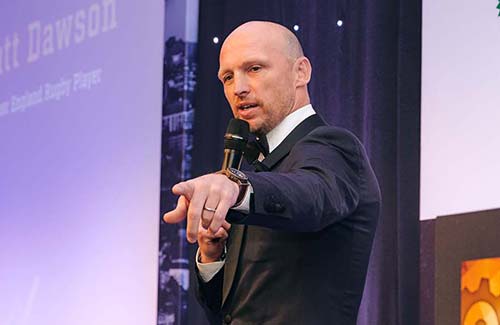 Matt Dawson speaking on stage.