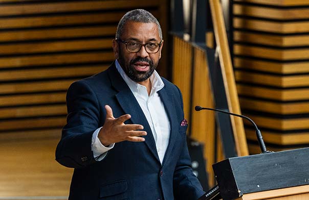 James Cleverly speaking on stage