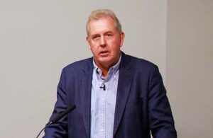 Lord Kim Darroch speaking on stage.