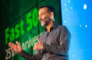 Dhiraj Mukherjee speaking on stage