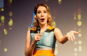 Katherine Ryan performing on stage.
