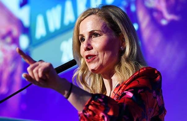 Sally Phillips on stage hosting an awards